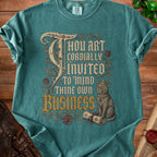 Teal t-shirt with "Thou Art Cordially Invited To Mind Thine Own Business" and a crowned cat.