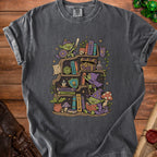 T-shirt graphic of goblins on a bookshelf with Dungeons & Dragons items.