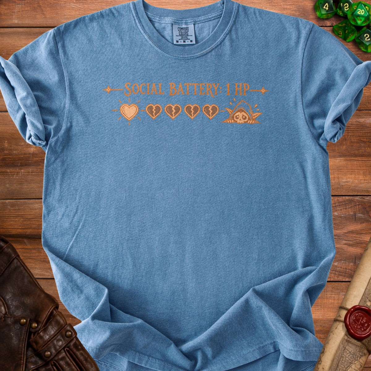 Blue t-shirt with "SOCIAL BATTERY: 1 HP" and game heart icons.
