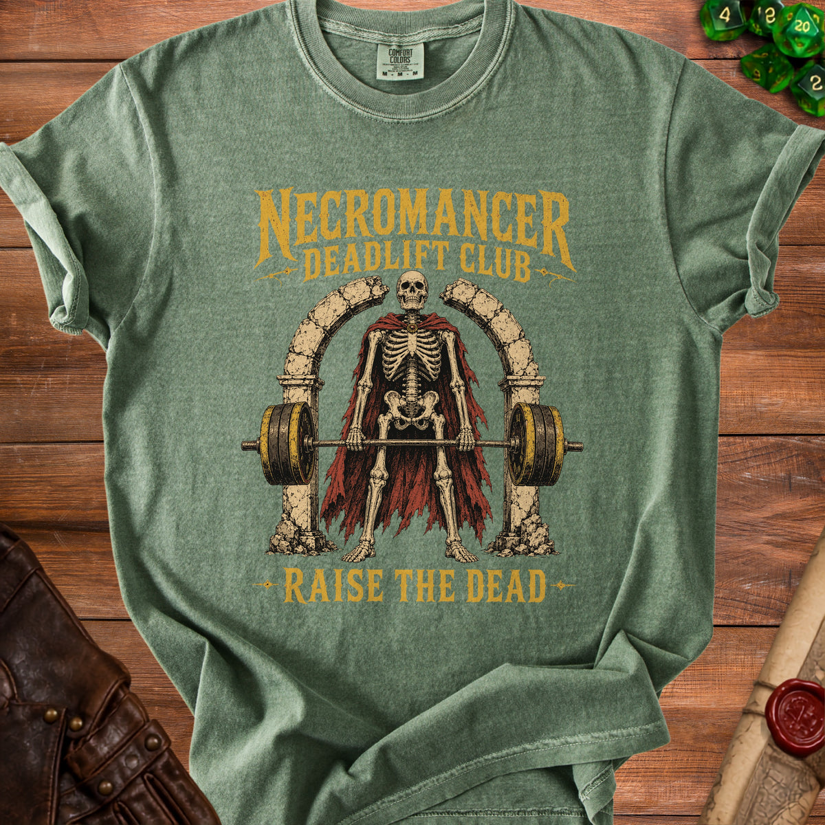 Green t-shirt with skeleton lifting weights, text "Necromancer Deadlift Club Raise The Dead".