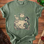 Green t-shirt with cartoon cats playing a tabletop role-playing game.