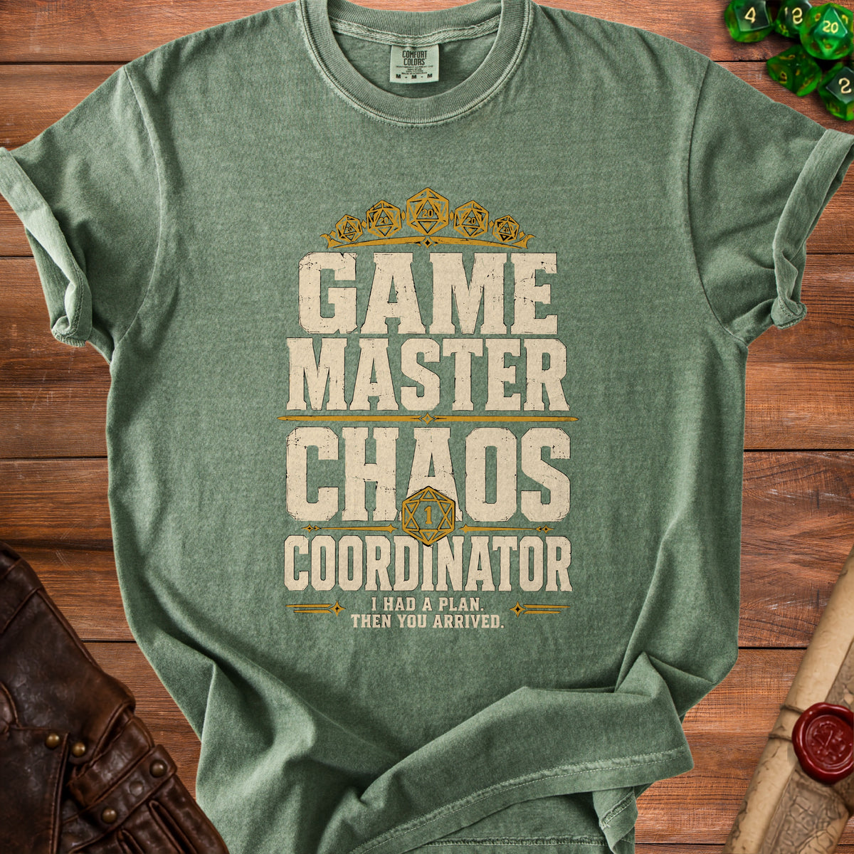 Green t-shirt with "Game Master Chaos Coordinator" text and dice design.