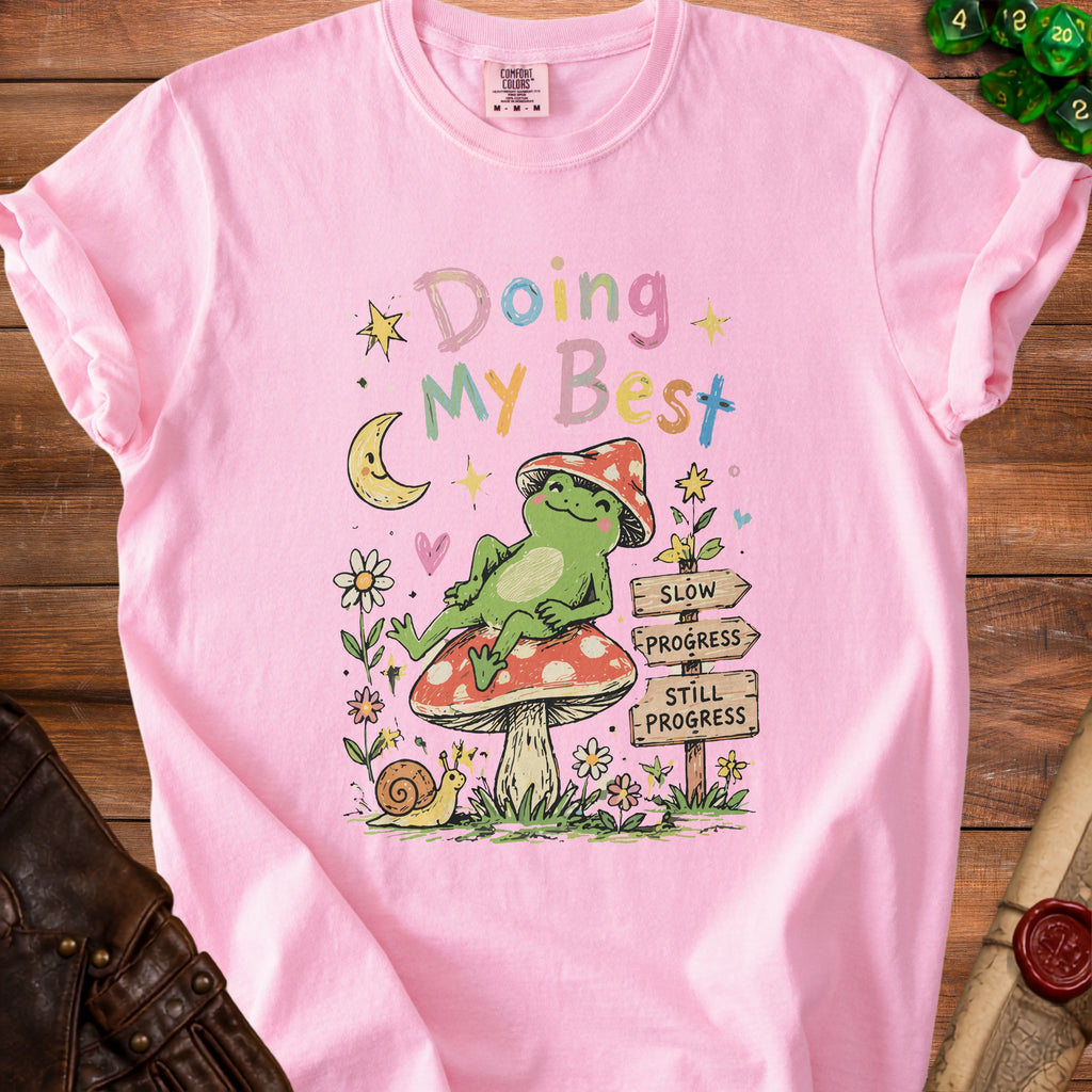 Pink t-shirt with a cartoon frog on a mushroom, reading "Doing My Best."