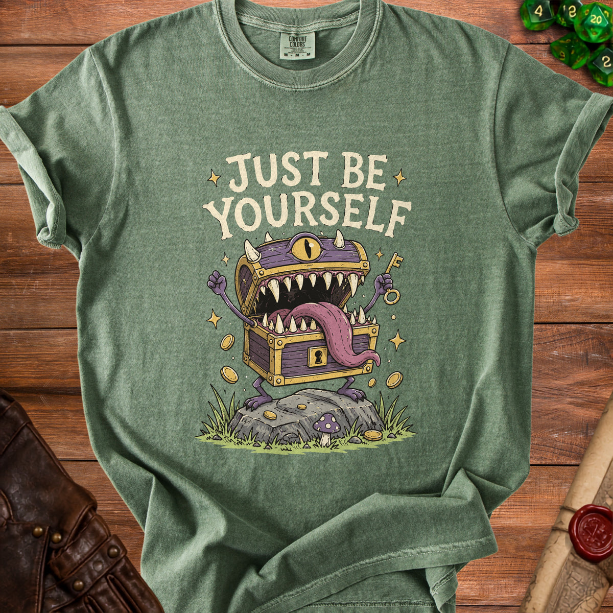 Green t-shirt with "JUST BE YOURSELF" text and a monster chest graphic.