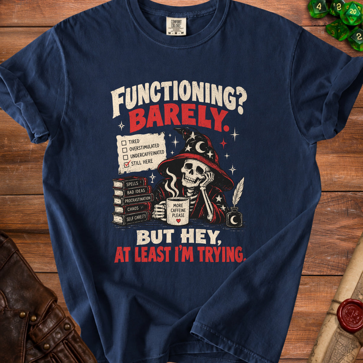 Dark blue t-shirt with skull wearing wizard hat, drinking coffee, list: Still Here.