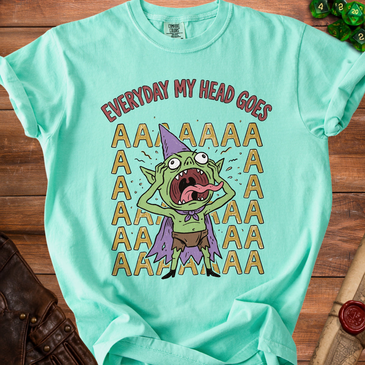 Green t-shirt with cartoon goblin and text "EVERYDAY MY HEAD GOES AAAAA".