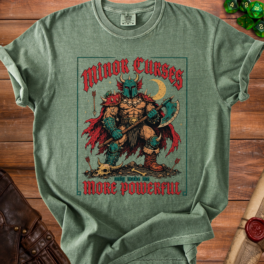 Green t-shirt with "Minor Curses only make me MORE POWERFUL" text and barbarian graphic.
