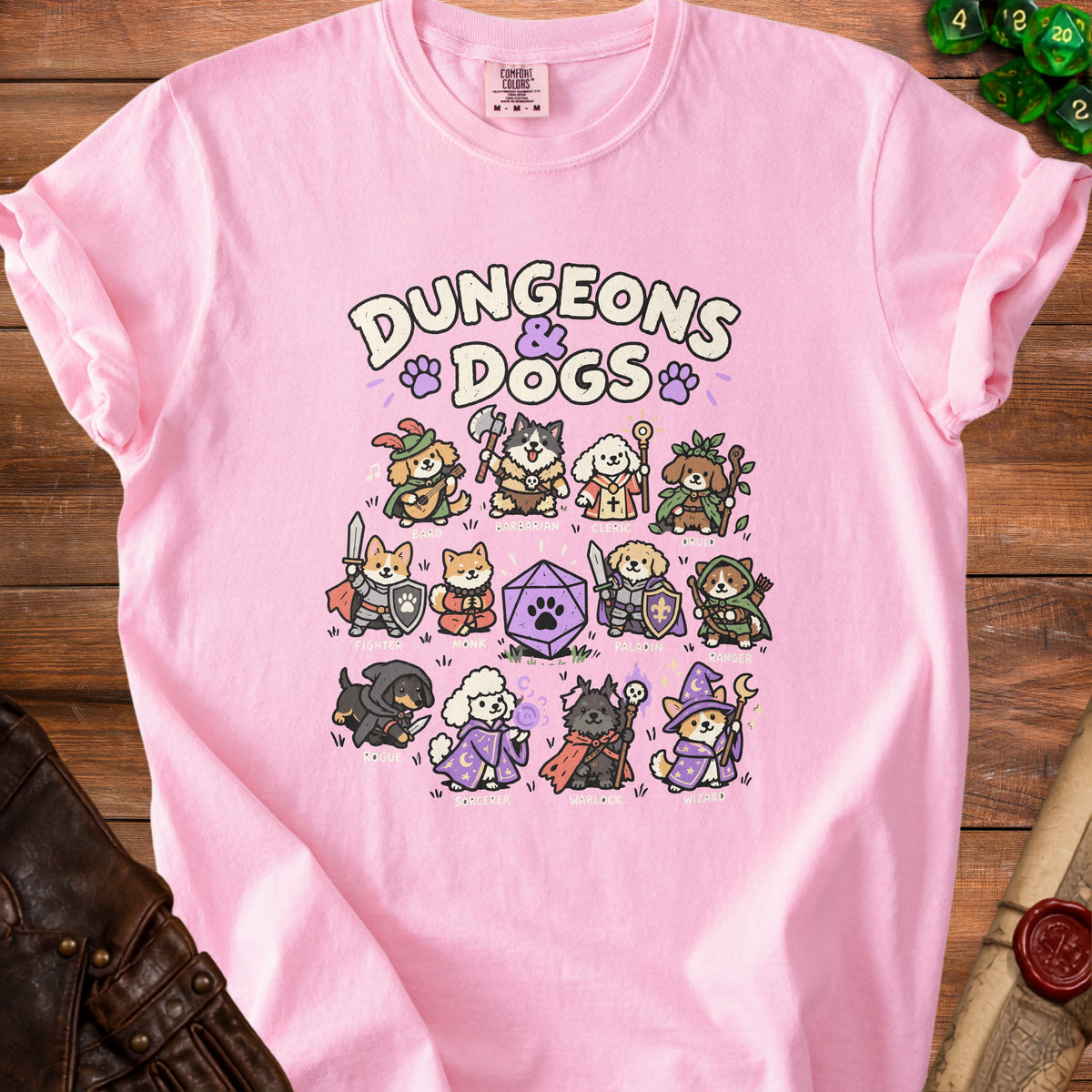 Pink t-shirt with "Dungeons & Dogs" and cartoon dogs in fantasy roles.