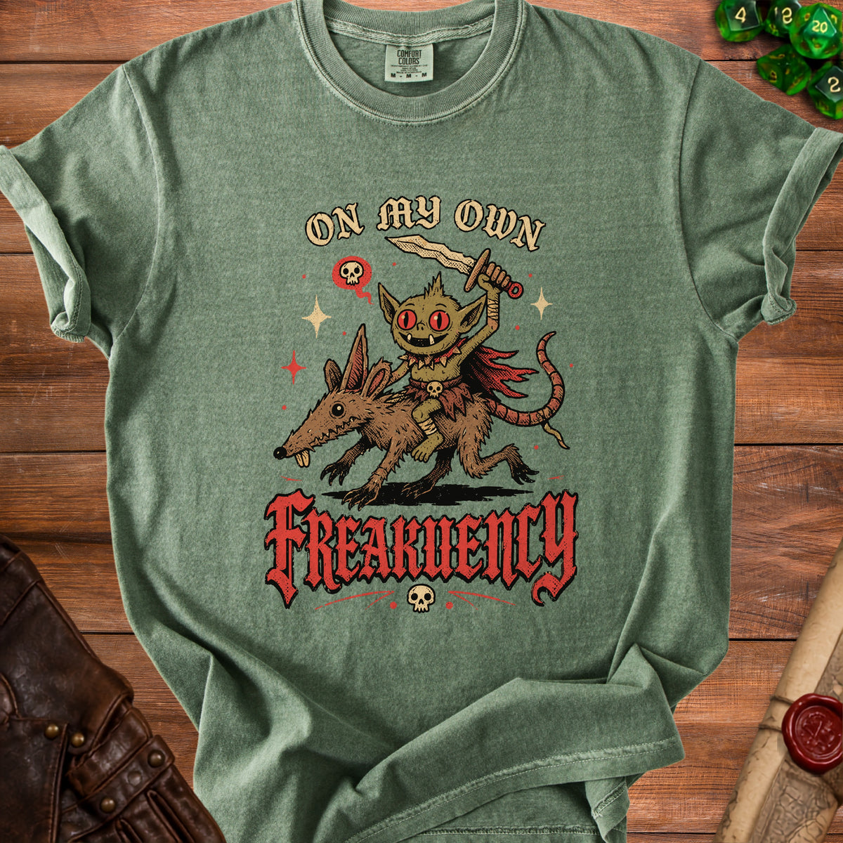 Green t-shirt with goblin riding rat and text "On My Own Frequency".