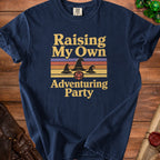 Navy t-shirt with "Raising My Own Adventuring Party" text, wizard hats, and a D20 die.