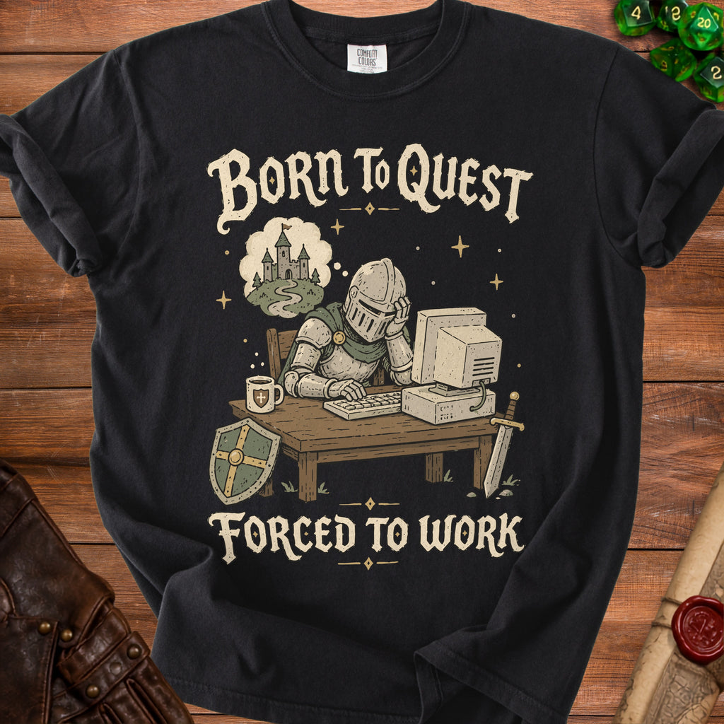 Black t-shirt with knight at desk dreaming of castle. Text: Born to Quest, Forced to Work.
