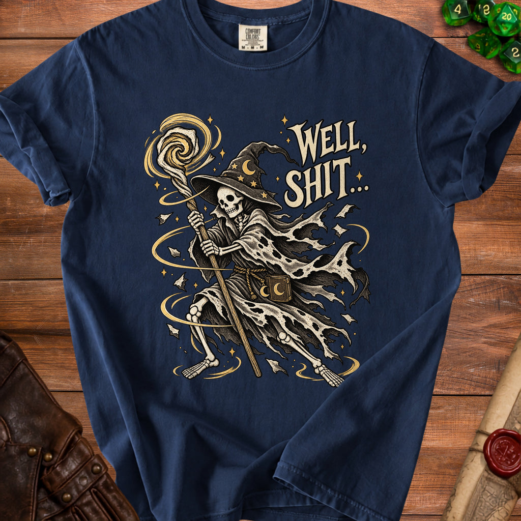 Skeleton wizard with staff and moon hat, "WELL, SHIT..." text on navy t-shirt.