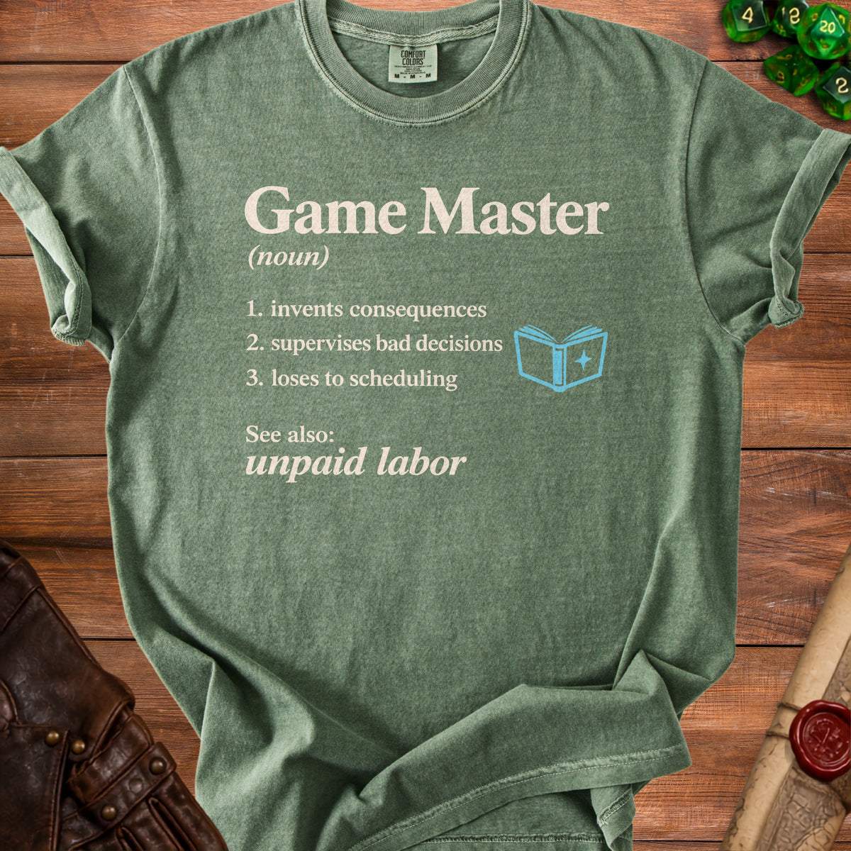 Green t-shirt with "Game Master" definition text and blue open book icon.