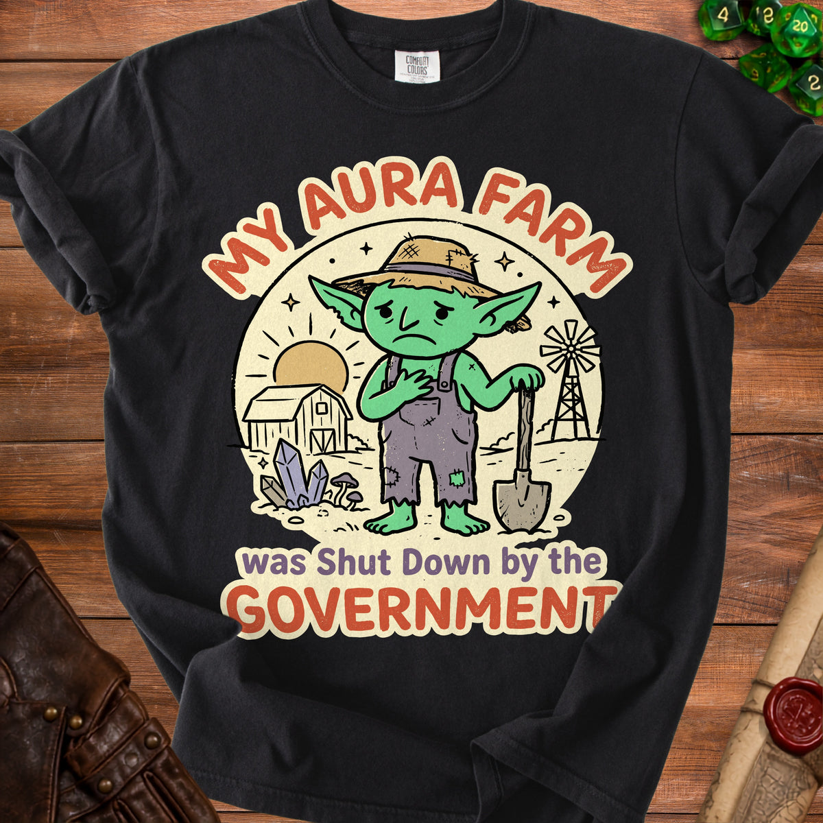 Black t-shirt with "My Aura Farm was Shut Down by the Government" text and a sad goblin farmer graphic.