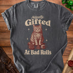 Dark gray t-shirt with a graphic of a cat and dice, reading "Naturally Gifted At Bad Rolls."
