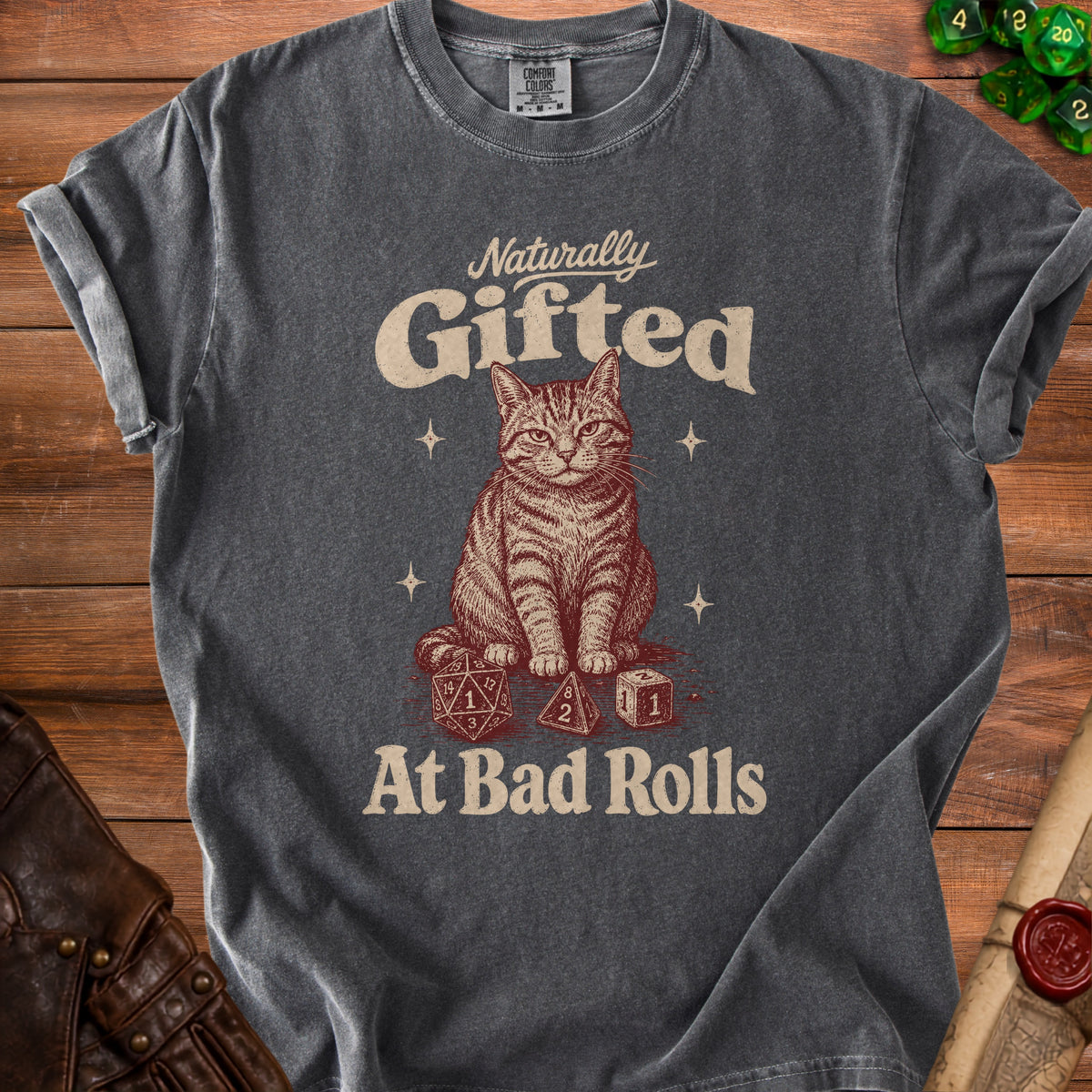 Dark gray t-shirt with a graphic of a cat and dice, reading "Naturally Gifted At Bad Rolls."