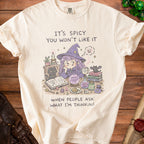 Cream t-shirt with witch graphic and text "It's Spicy, You Won't Like It".