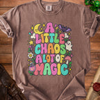 Brown t-shirt with colorful graphic reading "A Little Chaos A Lot of Magic."