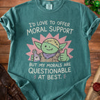 Green t-shirt with cartoon goblin holding potion and giving thumbs up, text reads "I'd love to offer moral support but my morals are questionable at best."