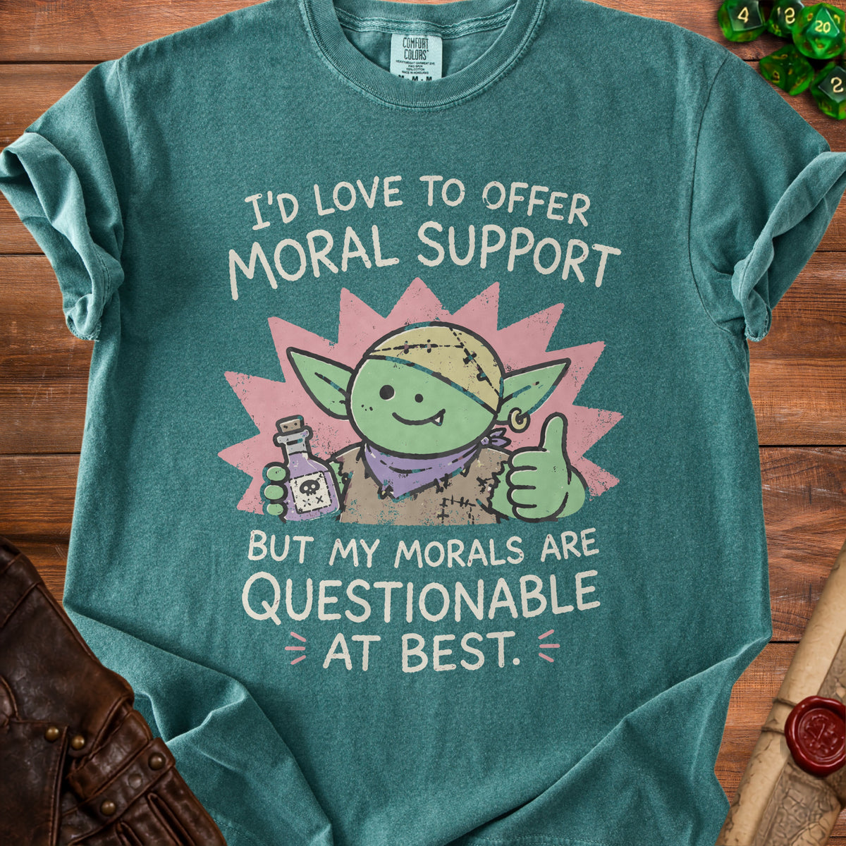 Green t-shirt with cartoon goblin holding potion and giving thumbs up, text reads "I'd love to offer moral support but my morals are questionable at best."