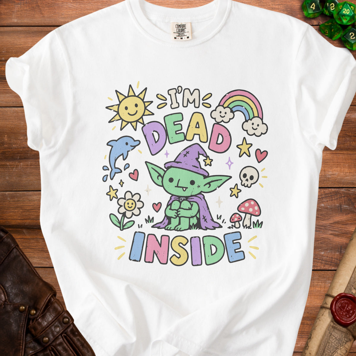 White t-shirt with "I'm Dead Inside" text and cartoon goblin, sun, rainbow, and dolphin.