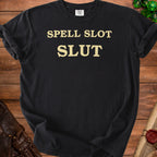 Black t-shirt with gold text "SPELL SLOT SLUT" and Comfort Colors tag.