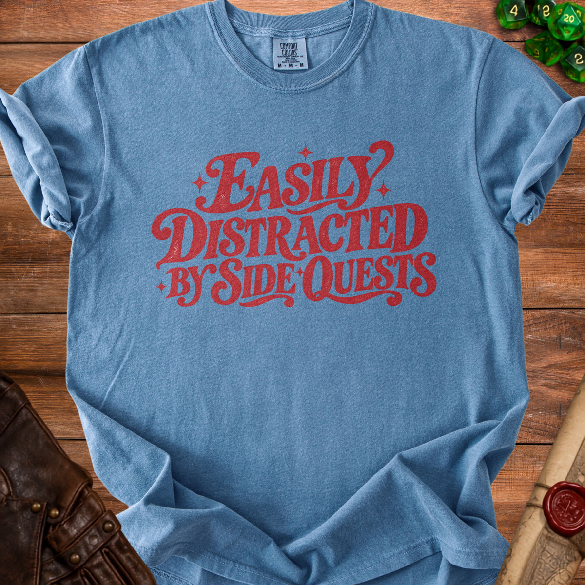 Blue t-shirt with red text "Easily Distracted by Side Quests".