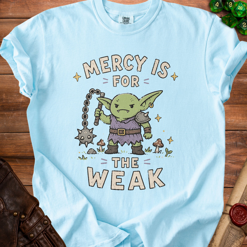 Light blue t-shirt with cartoon goblin and text "Mercy is for the weak".