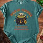 Teal shirt with cauldron, skull, and text "Hold Up, Pardner I'm Overstimulated And Fermenting Rage".