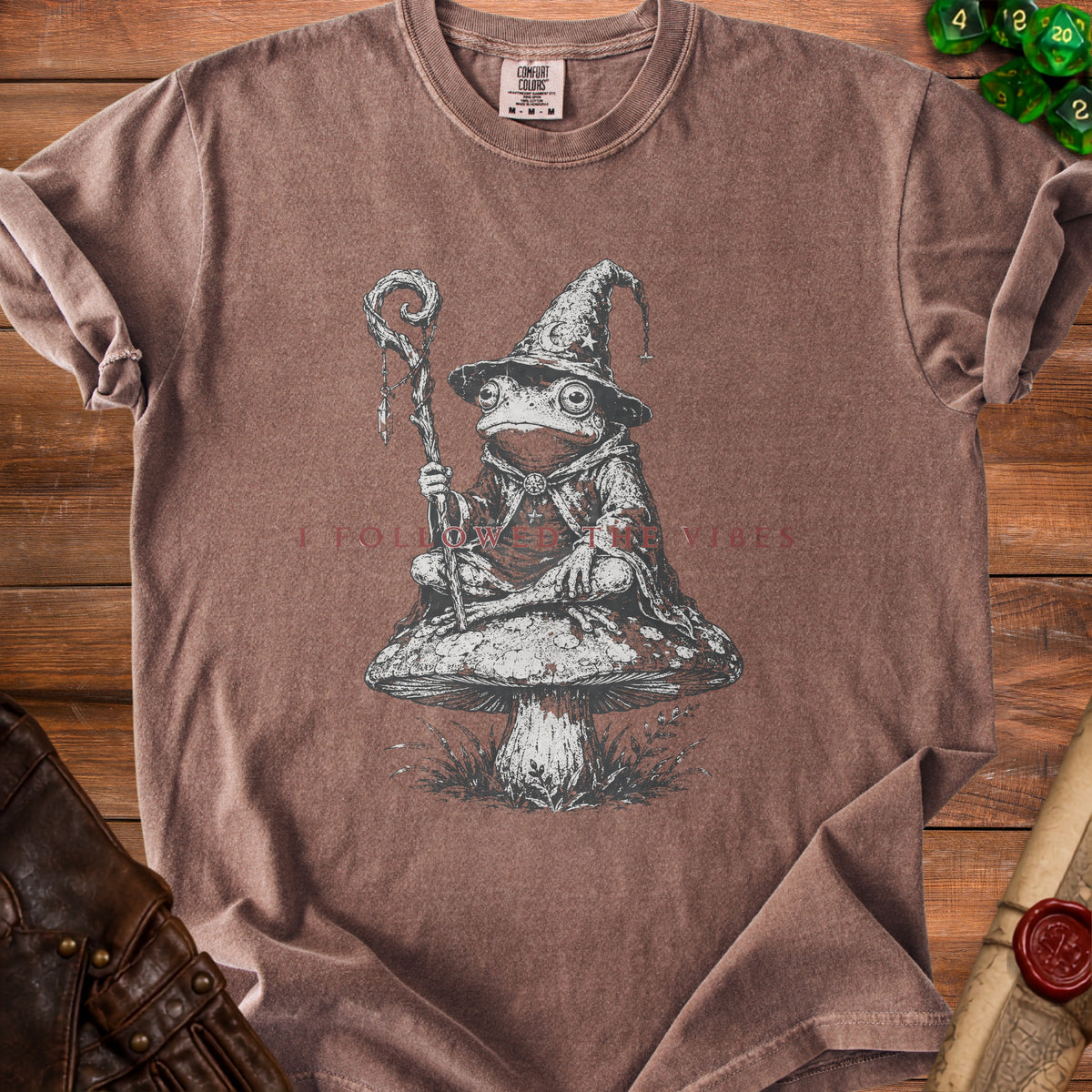 T-shirt with frog wizard graphic sitting on a mushroom. "I FOLLOWED THE VIBES" text.