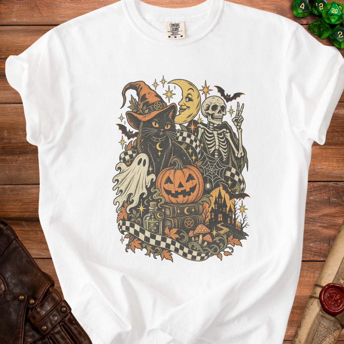 White t-shirt with a vintage Halloween graphic of a black cat, skeleton, and spooky elements.