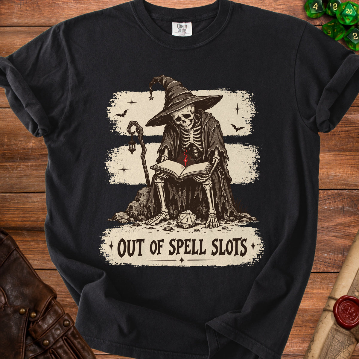 Black t-shirt with a skeleton wizard reading a book, text reads "OUT OF SPELL SLOTS."