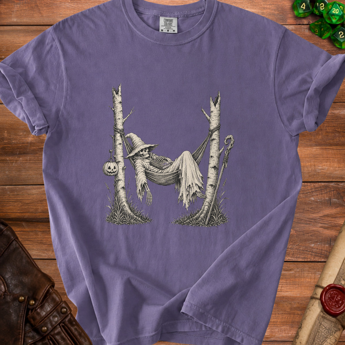 Skeleton in witch hat and tattered robe rests in hammock between trees.