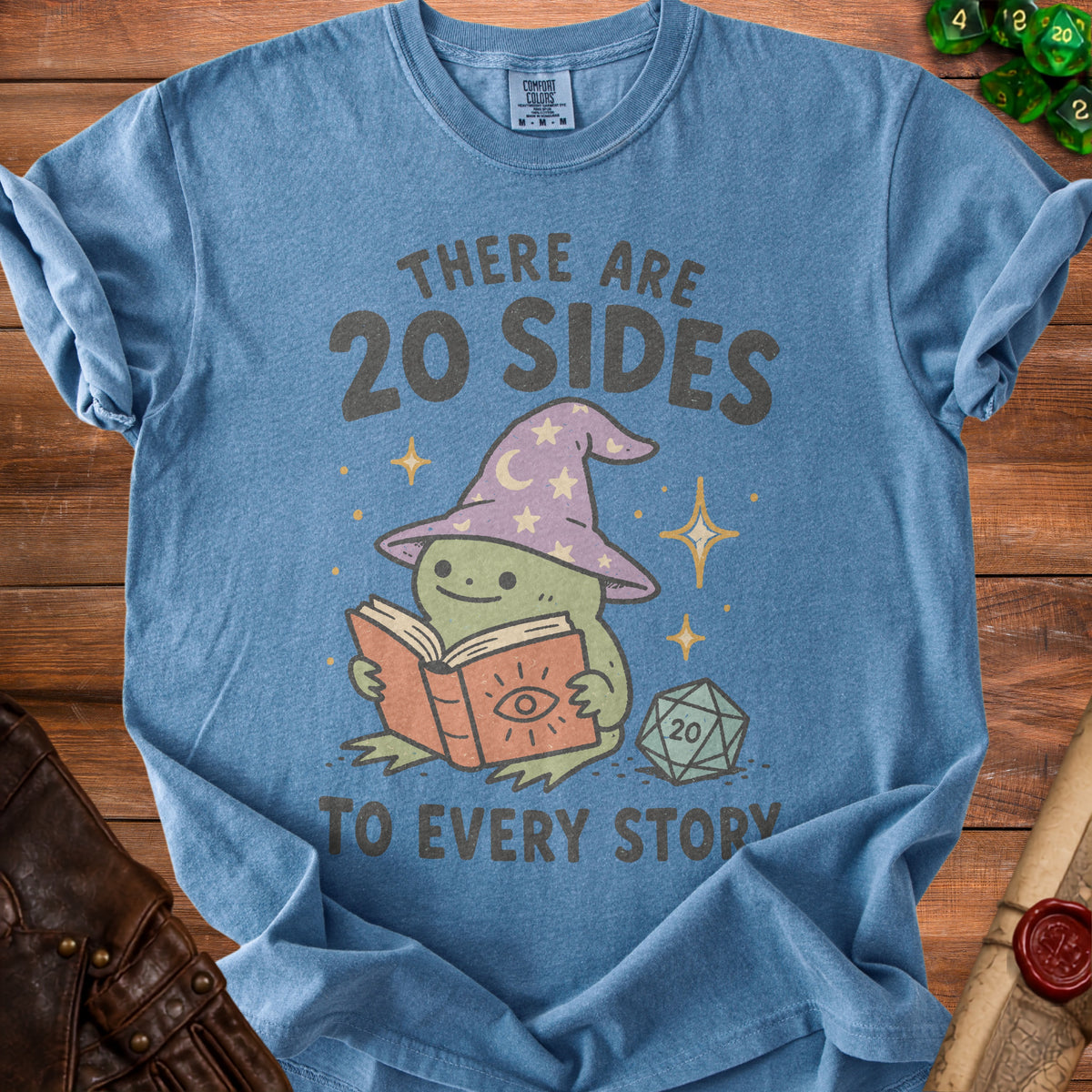 Blue t-shirt with wizard frog reading a book, "There are 20 sides to every story" text.