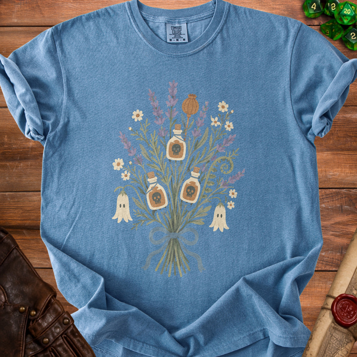 Blue t-shirt with a bouquet of spooky, witchy, and floral elements.