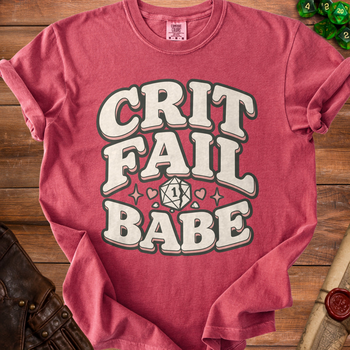 Crimson t-shirt with "CRIT FAIL BABE" text and a broken D20 die.