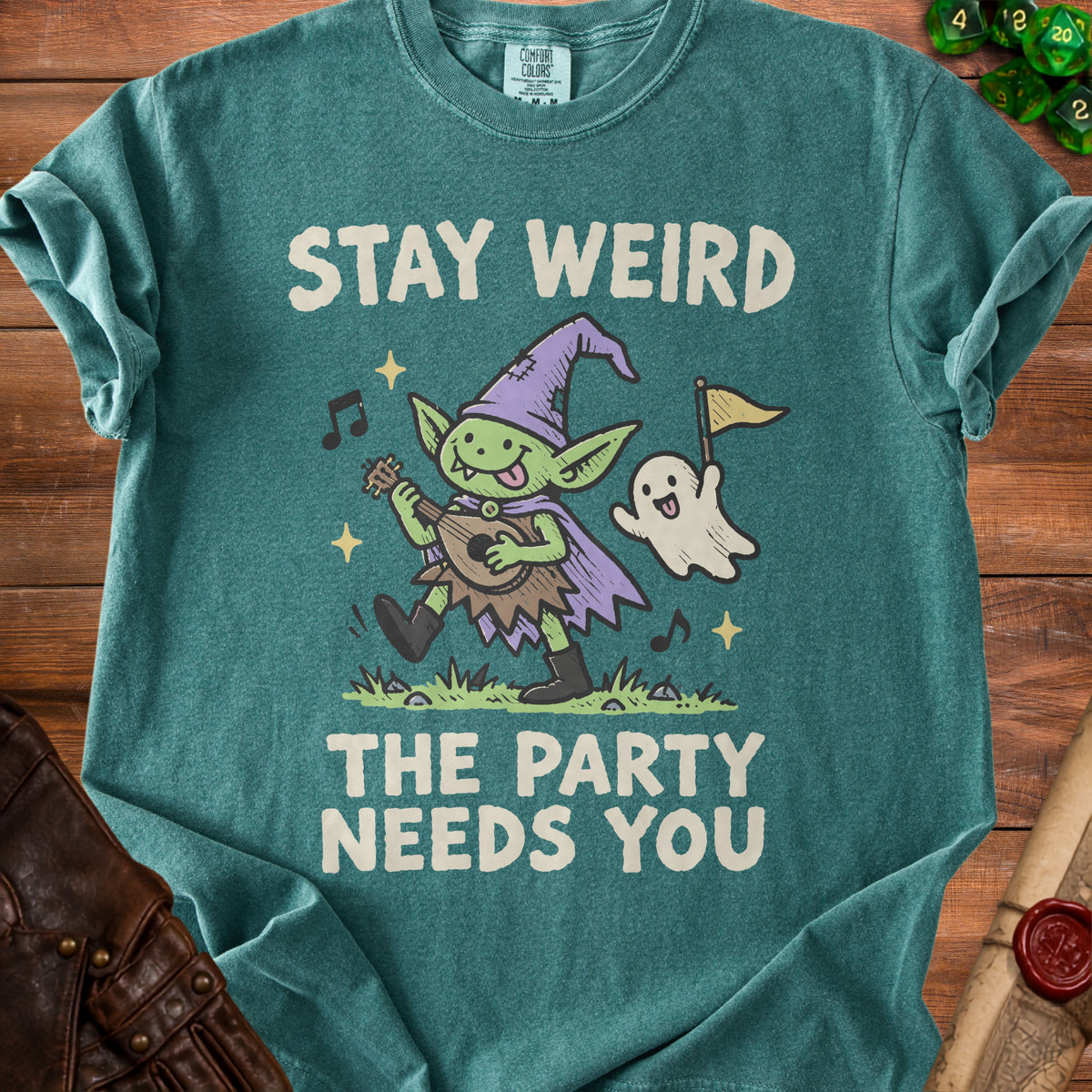 Green t-shirt with "Stay Weird The Party Needs You" and a goblin playing a lute.