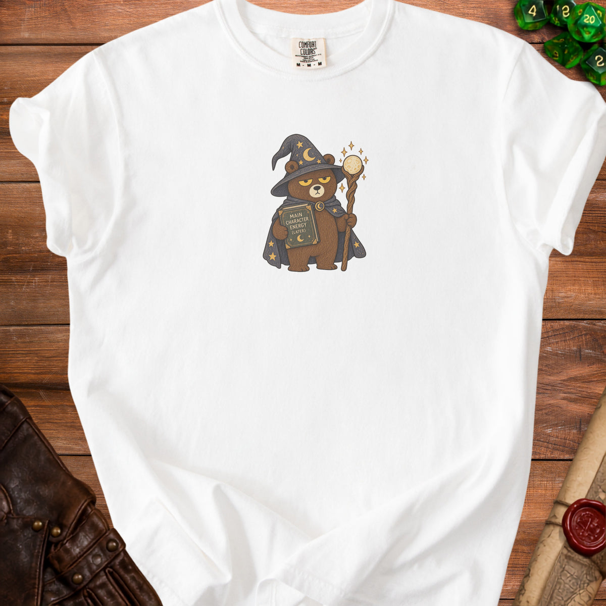 White t-shirt with embroidered wizard bear holding a book and staff.