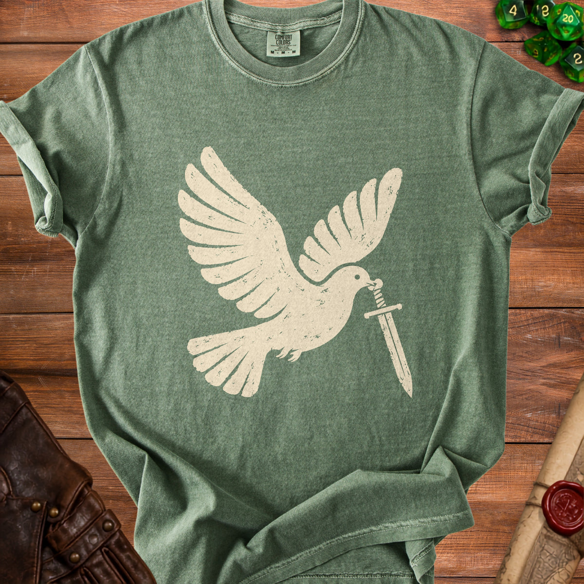 Green t-shirt with a cream-colored dove holding a sword in its beak.