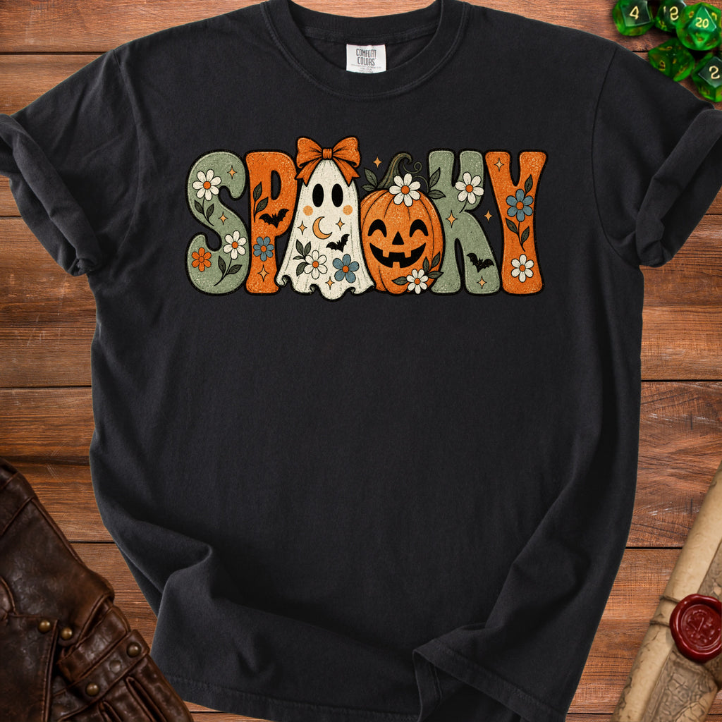 Black t-shirt with groovy "SPOOKY" text featuring ghost, pumpkin, and floral designs.