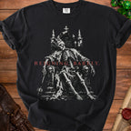 Black t-shirt with skeleton on a throne, reads "Reigning Barely."