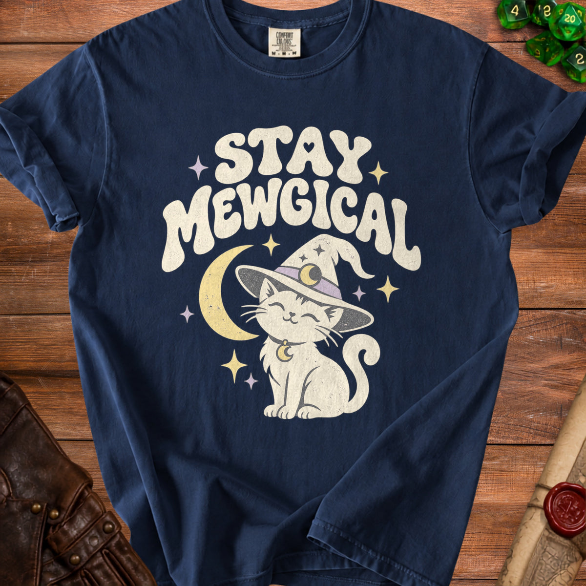 Navy t-shirt with white text "STAY MEWGICAL" above a cartoon cat in a witch hat.