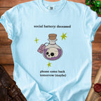 Light blue t-shirt with "social battery: deceased" and skull in potion.
