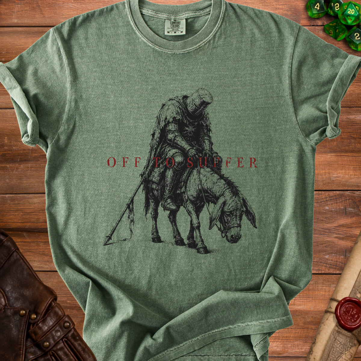 Green t-shirt with medieval knight riding a donkey and text "OFF TO SUFFER".