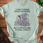 Light mint green t-shirt with skeleton wizard graphic and text "I DON'T KNOW WHAT I'M DOING BUT I WOULD LIKE TO ROLL FOR IT!"
