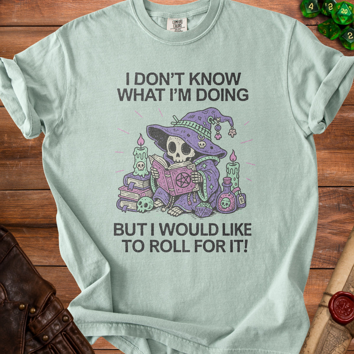 Light mint green t-shirt with skeleton wizard graphic and text "I DON'T KNOW WHAT I'M DOING BUT I WOULD LIKE TO ROLL FOR IT!"