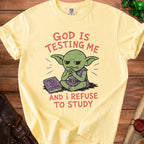 Yellow t-shirt with graphic of green goblin refusing to study a book.