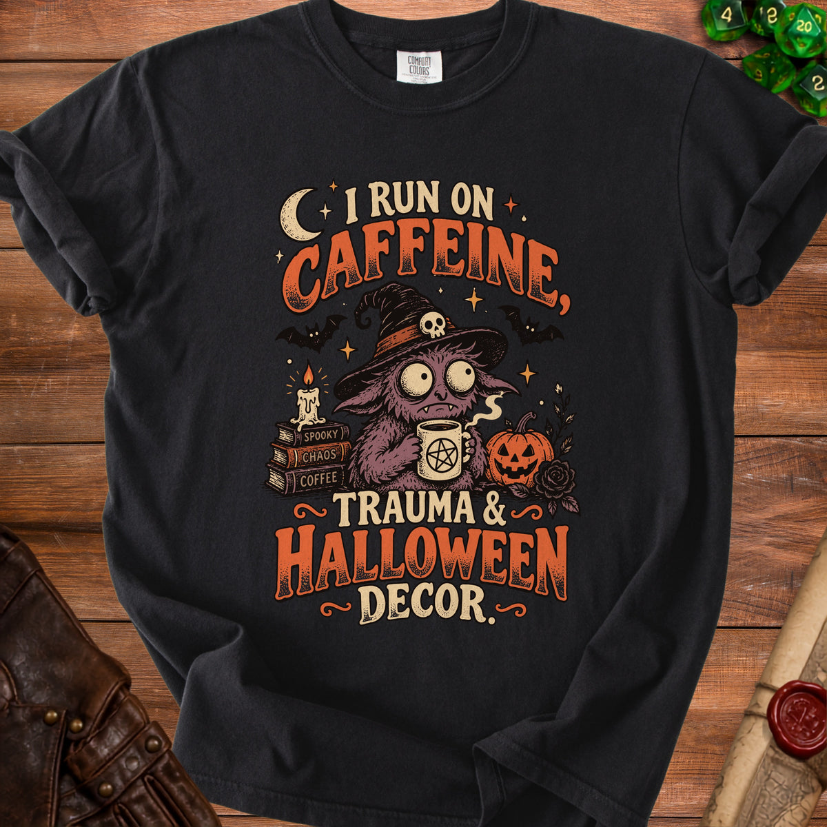 Black t-shirt with "I run on caffeine, trauma & Halloween decor." graphic.