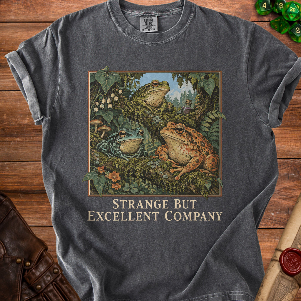 T-shirt with three frogs on a mossy branch and text "STRANGE BUT EXCELLENT COMPANY".
