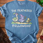 Blue t-shirt with "The Feathered Fellowship" and cartoon animals in medieval attire.